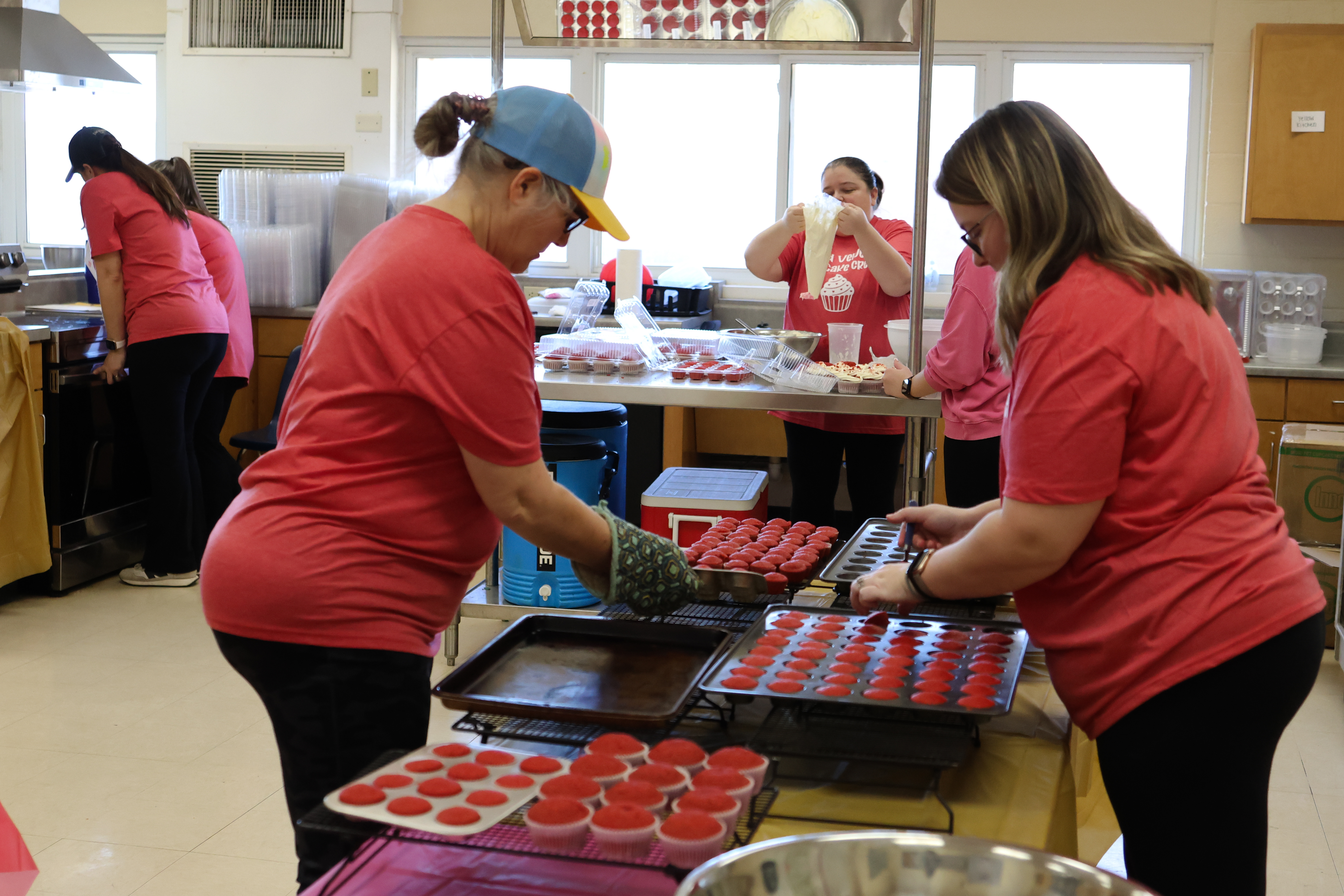 Volunteers bake red velvet cupcakes for the CAYA House's annual Valentine's Day fundraiser on Friday, Feb. 13, 2026, in Lexington, Georgia. The team set up in Oglethorpe County High School's teaching kitchen, with each volunteer having their own task to maximize efficiency. (Photo/Sydney Shankman) 