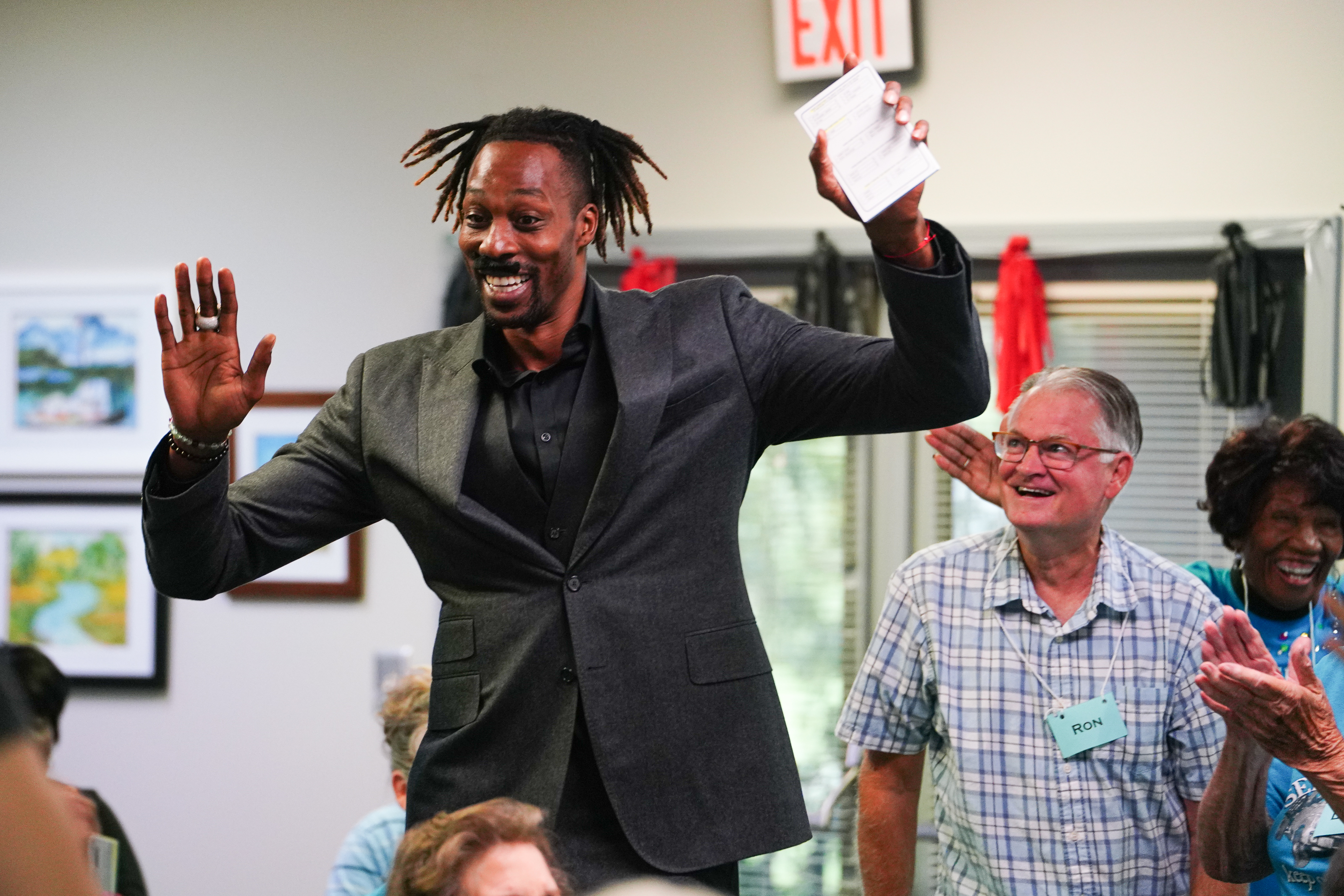 NBA All Star Dwight Howard dances next to Ron Leonard and Roz Echols as he enters the senior center on Friday morning. Howard hosted 'Family Feud' at the Oglethorpe Senior Center in Crawford, Georgia. (Sidney Chansamone/The Oglethorpe Echo)