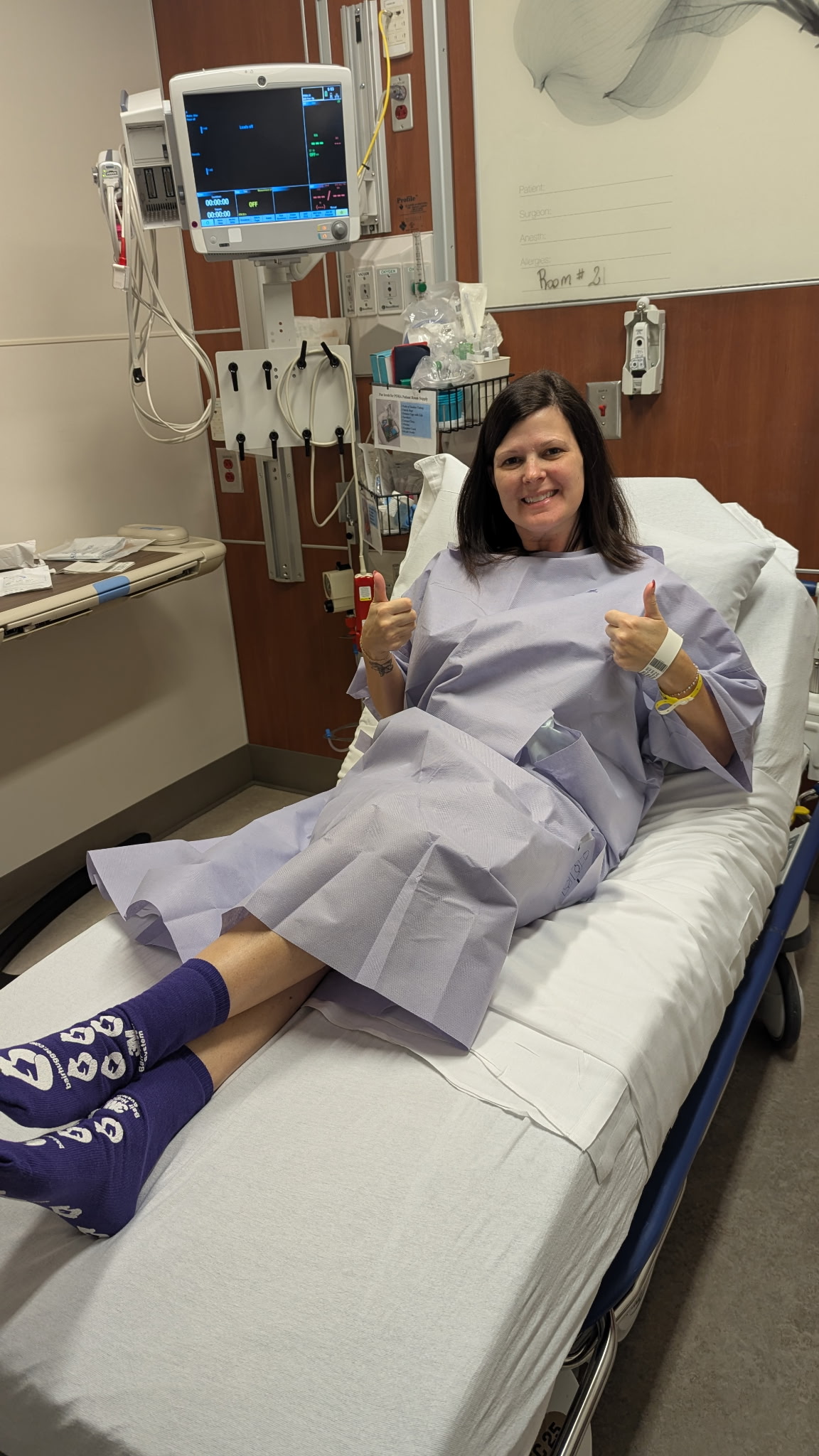 April poses in her hospital bed