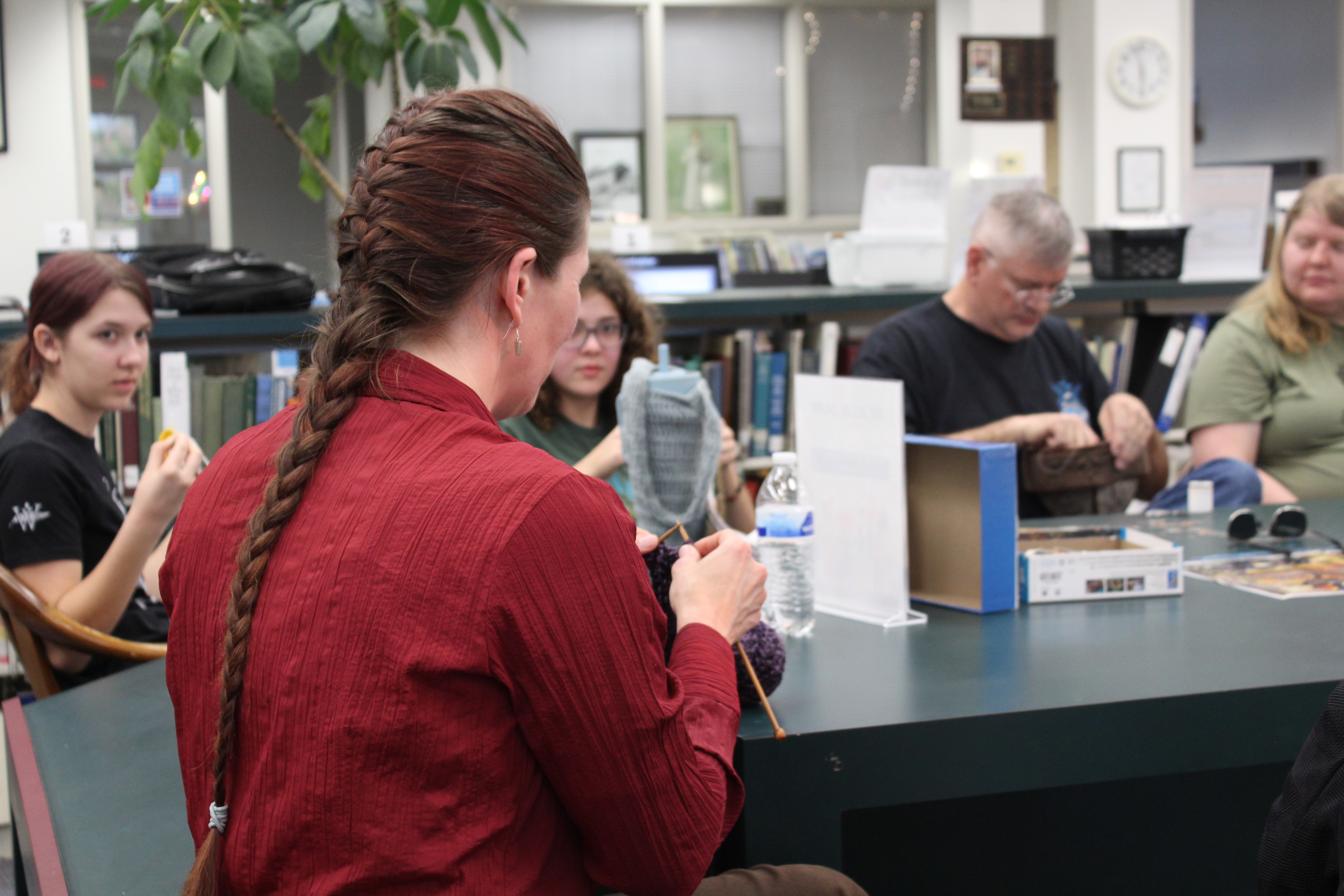 Katherine Ratcliffe knits at Hooked on a Good Yarn, the fiber arts group she founded, at the Oglethorpe County Library on Friday, Feb. 28. “My mom taught me to knit when I was young, but beyond making one (thing), I never really got involved in it,” Ratcliffe said. “But I thought it would be really neat to connect with other people in the community, and then we could, like, learn from each other.” (Photo/Emily Slepsky)