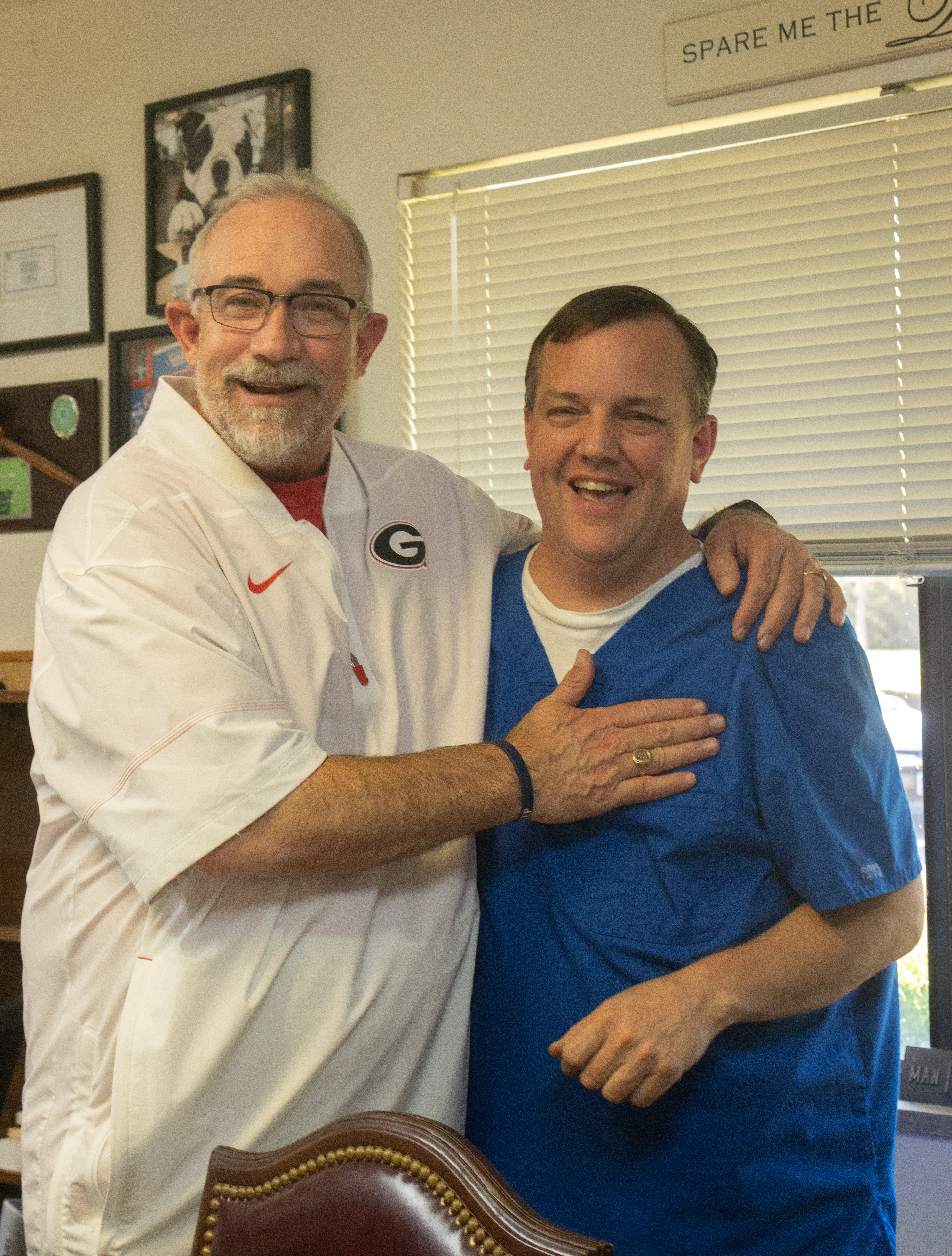 David Moore (right) and Chris Wrenn enjoy a light moment at Quiet Oaks Health Care in Crawford. Moore, a CNA for 31 years, said Wrenn helps motivate and support him as an administrator and coworker. (SARAH ROPER/THE OGLETHORPE ECHO)