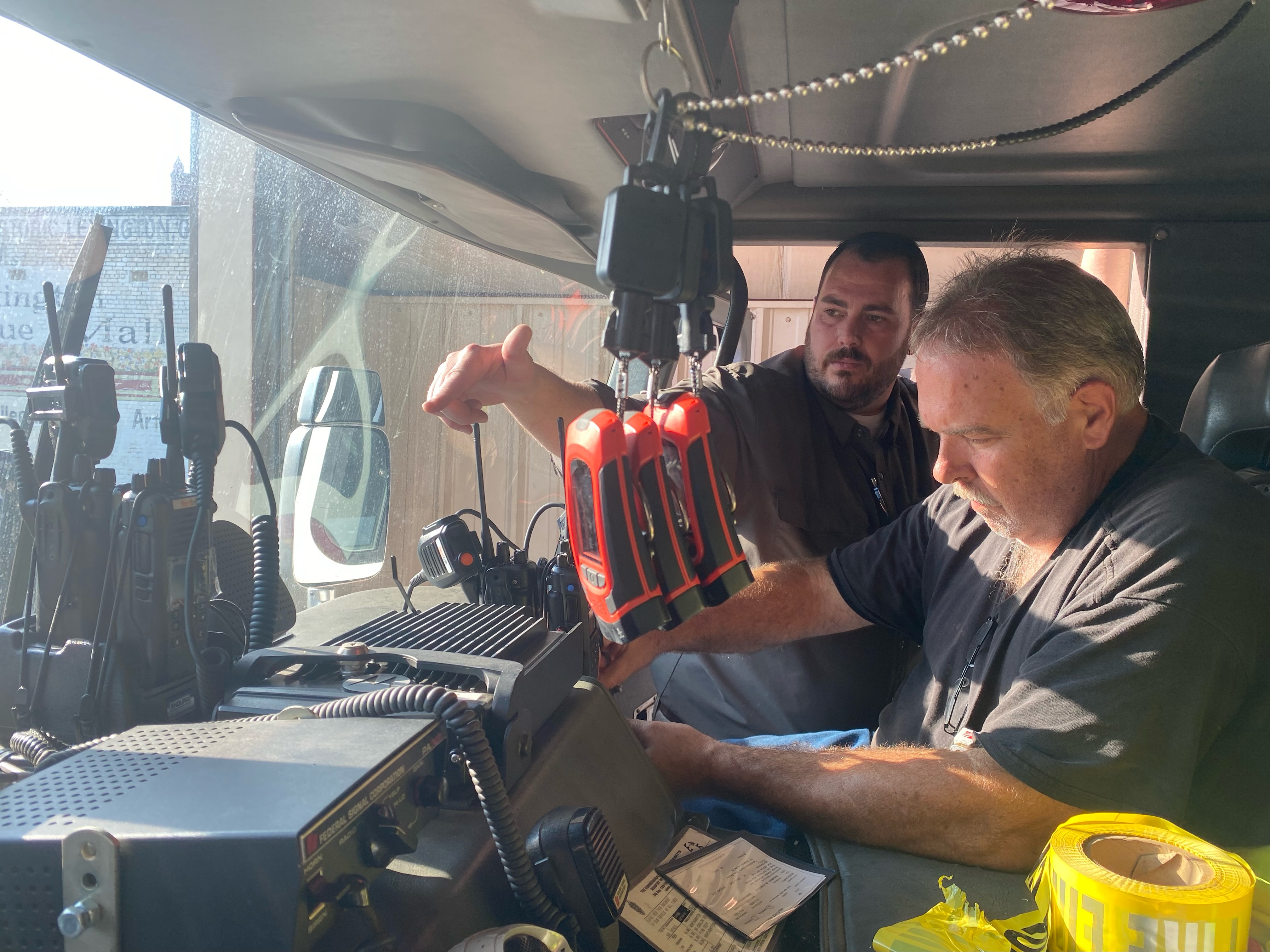 Oglethorpe County 911 director James “Junior” Jackson (left) works with John Smith to install new radios in the county’s emergency vehicles. The new system should be completed by the end of January.