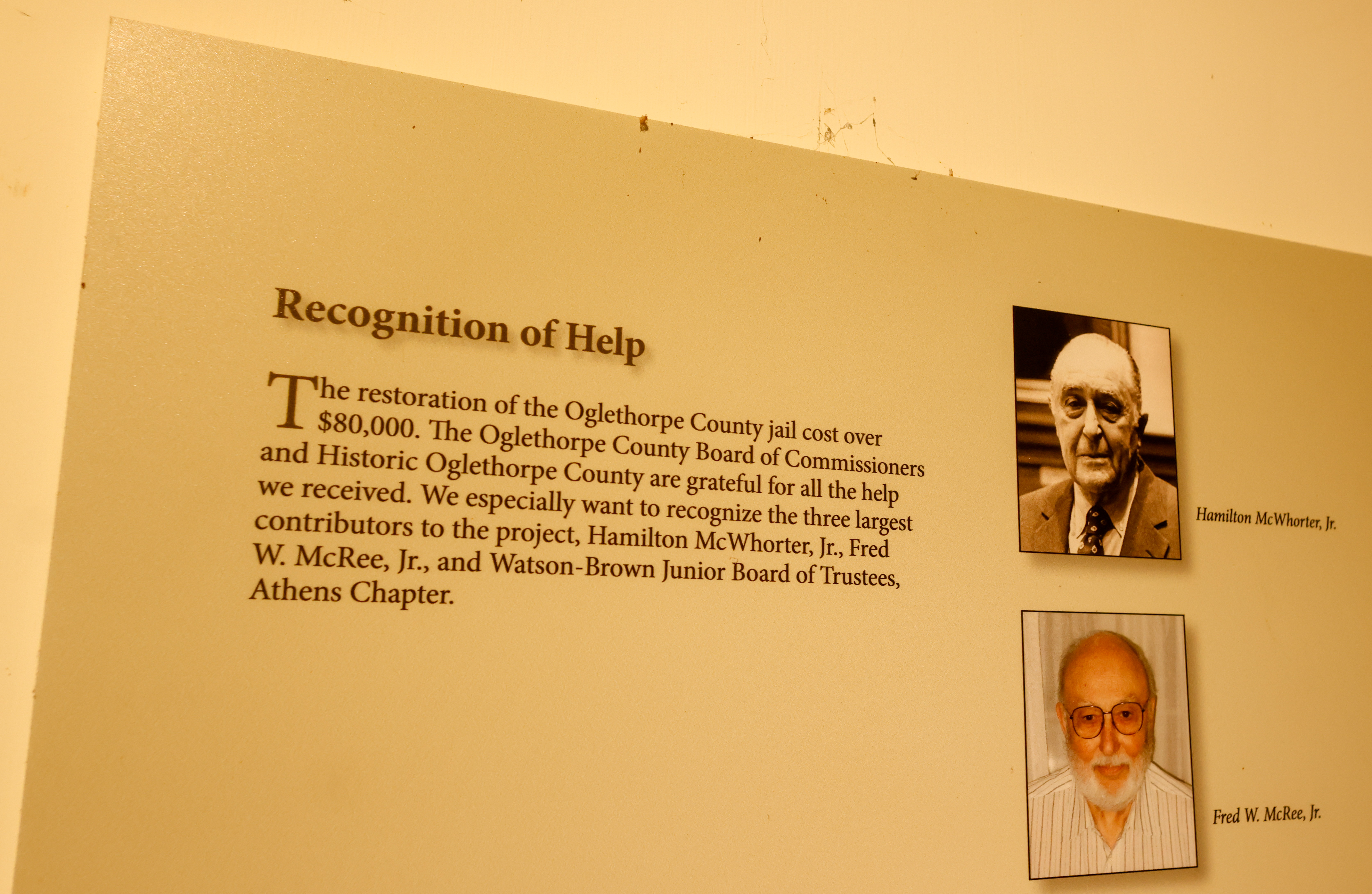A plaque honoring Hamilton McWhorter Jr. hangs on the wall of the Historic Oglethorpe County jail on Aug. 28, 2025. McWhorter was a key contributor to the restoration of the jail, a four-year project that began in 2008. (Photo/Susanna Johnson)