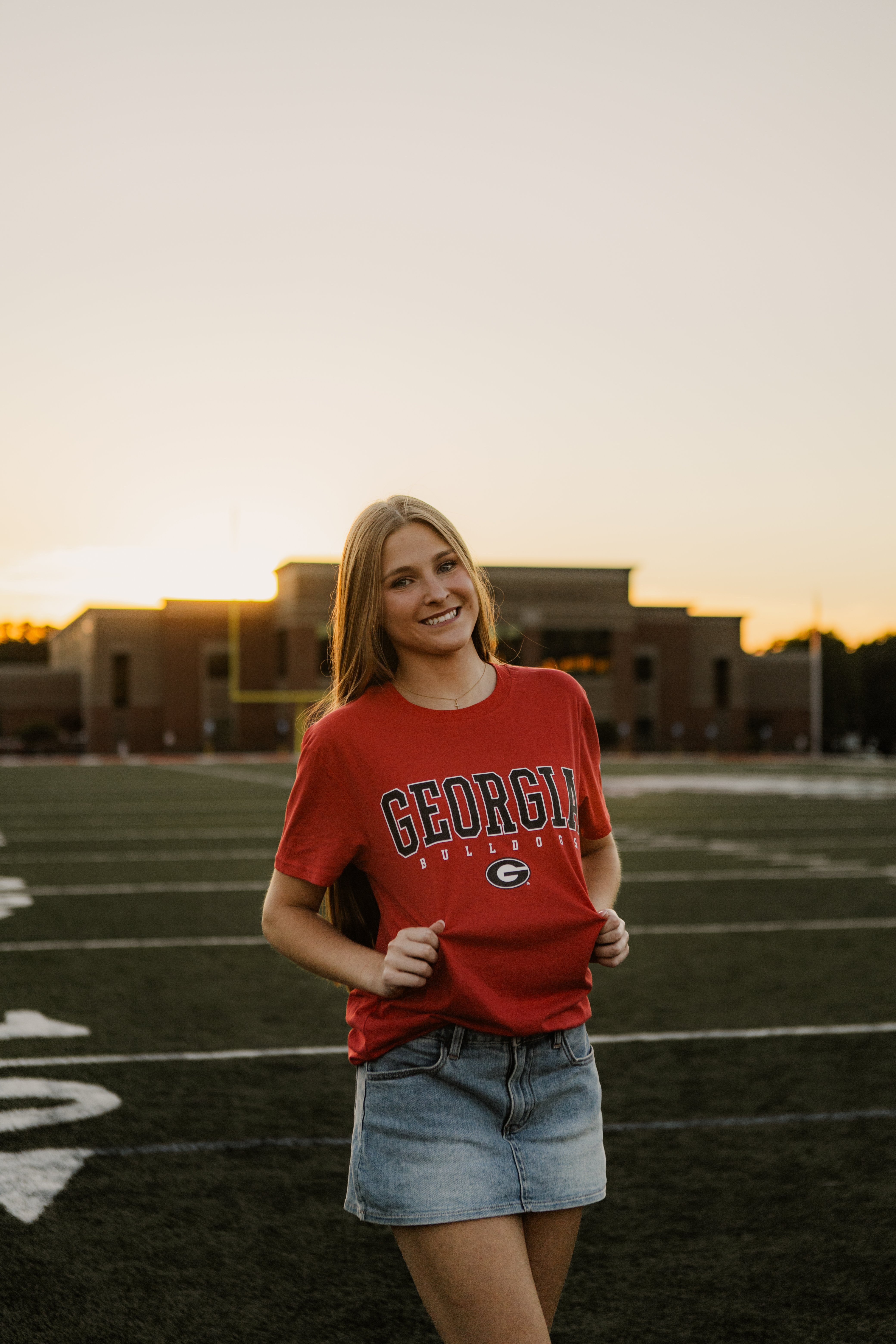 Mary Grace Watson, a first-year student at UGA, poses for a photo on the football field at Madison County High School. She graduated in May 2026. (Photo/Zaire Rushing-Simpson).