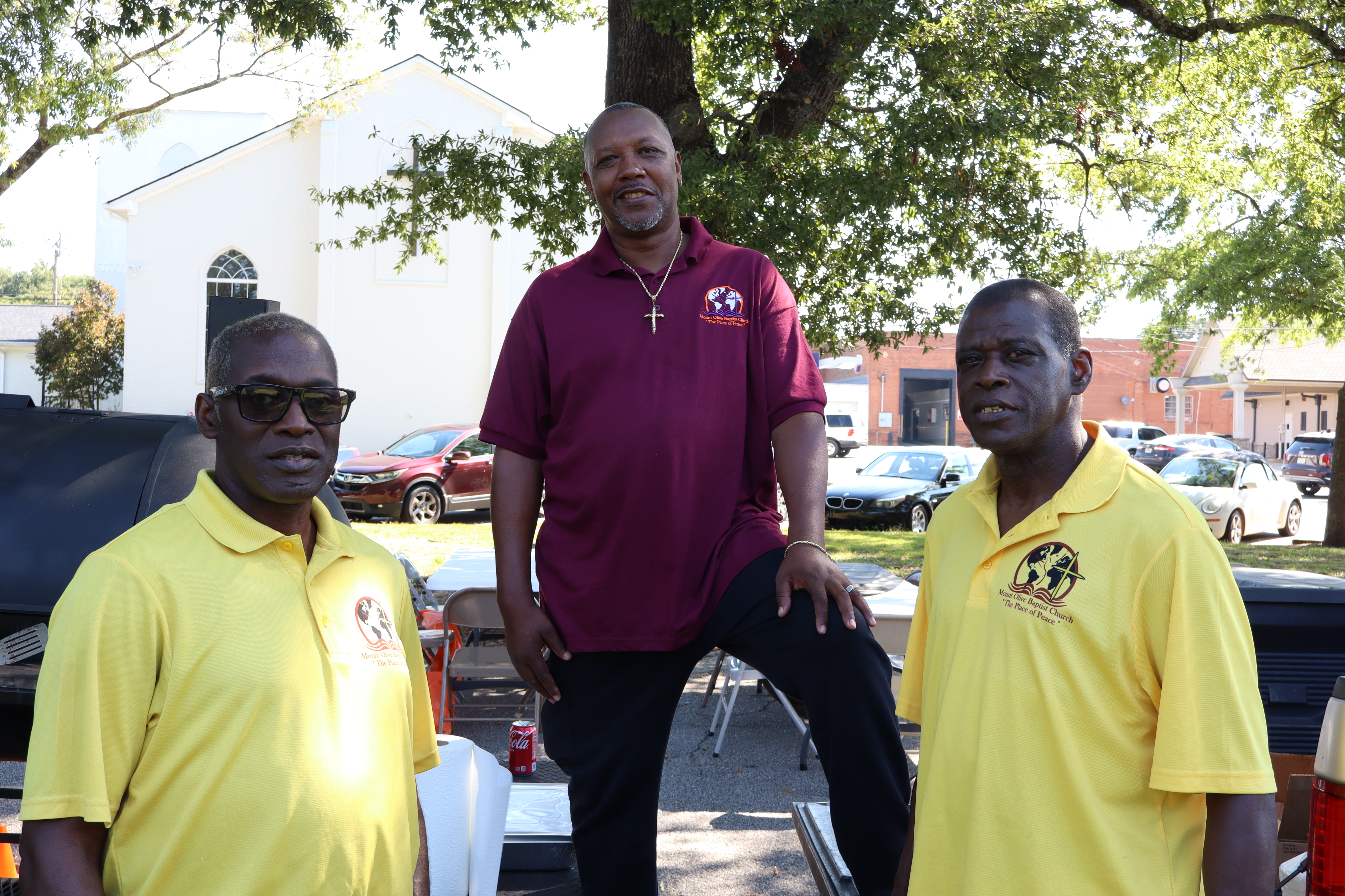 Kerry Smith (from left), Stacy Taylor and Andrew Smith wear their church shirts as they assist with Community Fun and Resource Day on Sept. 13 at the Crawford Depot. Health care professionals and other service providers offered their services at the event. (Molly Moore/The Oglethorpe Echo)