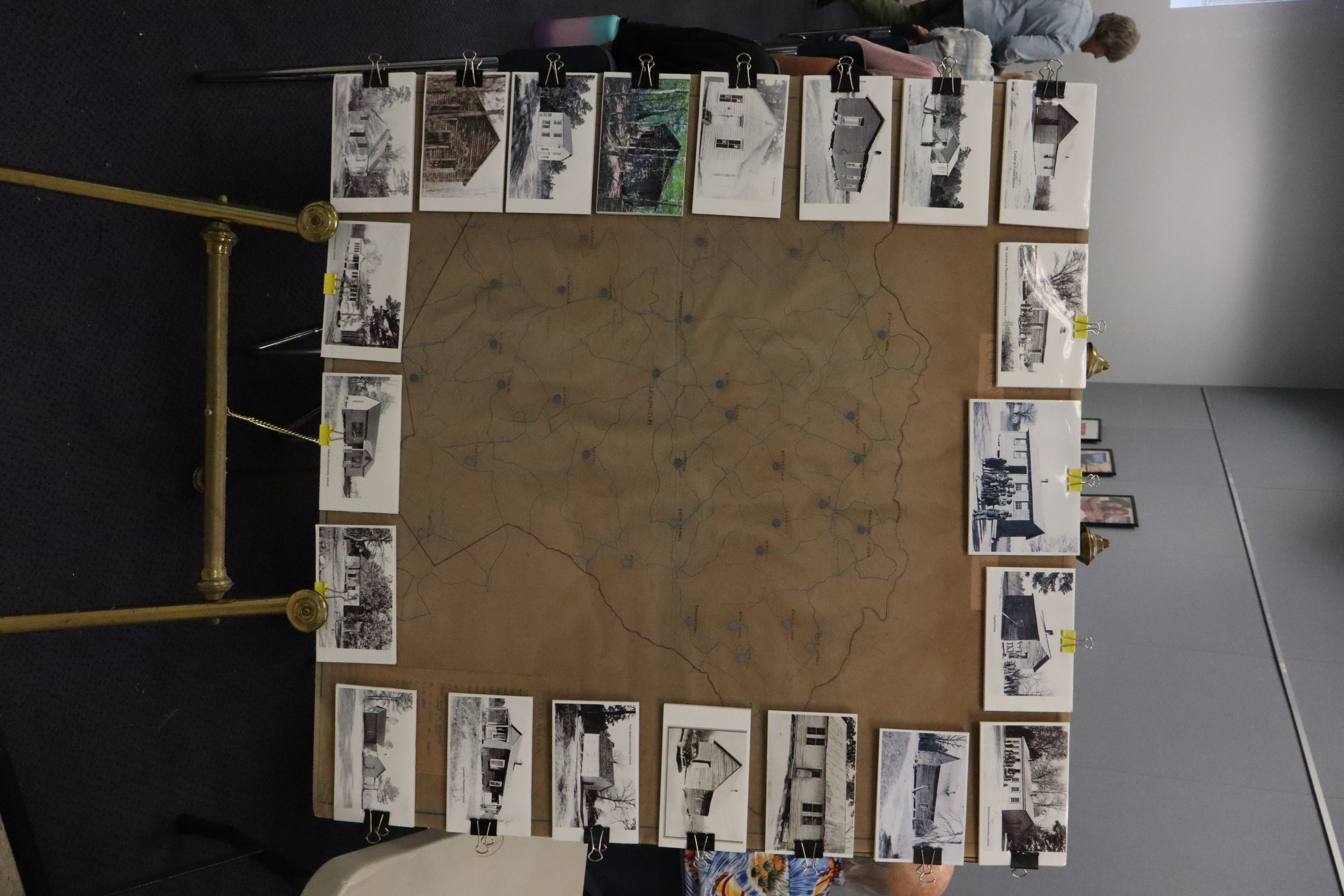 A map displaying the locations of one-room schools, along with photographs, was featured at the entrance of the Historic Oglethorpe monthly meeting on Sept. 23. Because many of the schoolhouses were torn down, they have been difficult for the Digital Atlas Project to document. (Photo/Molly Moore)