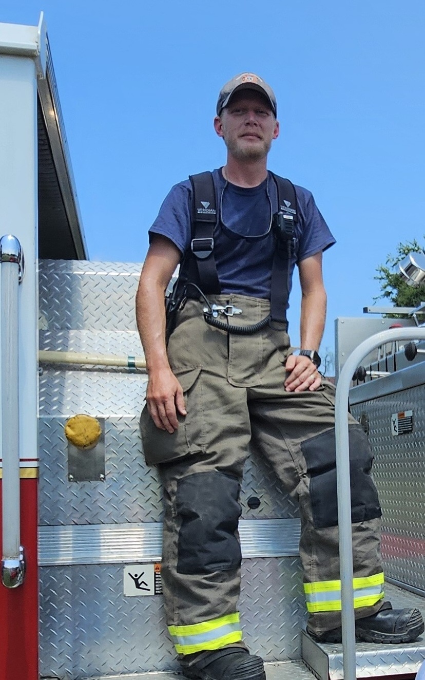 Jonathan Doss sits atop one of the station's four firetrucks. Doss is the station's training officer and hopes to get all volunteers Firefighter 1 certified. (Submitted Photo/Jennifer King)