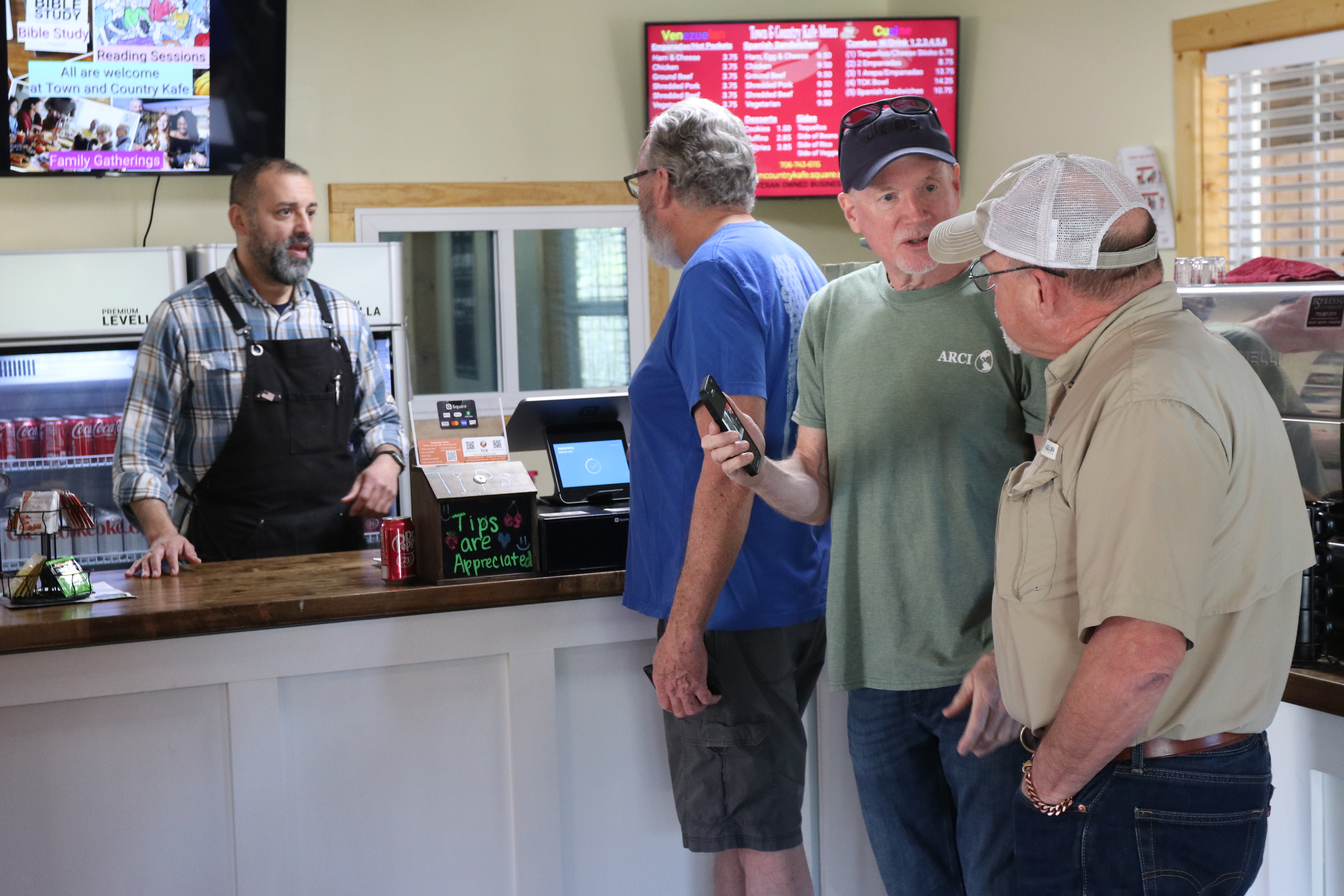 Co-owner Willie Torres takes orders from Terry Allen, founder of the Bulldog British Classics Car Club, Gary Whiting, club member, and Rob Stewart, club event planner, at Town and Country Kafe, on Wednesday, Feb. 26, 2025. The Bulldog British Classics Car Club has hosted two car shows at the cafe and will return for another show on May 17 at 11:30 a.m. (Photo/Adriana Cascio)