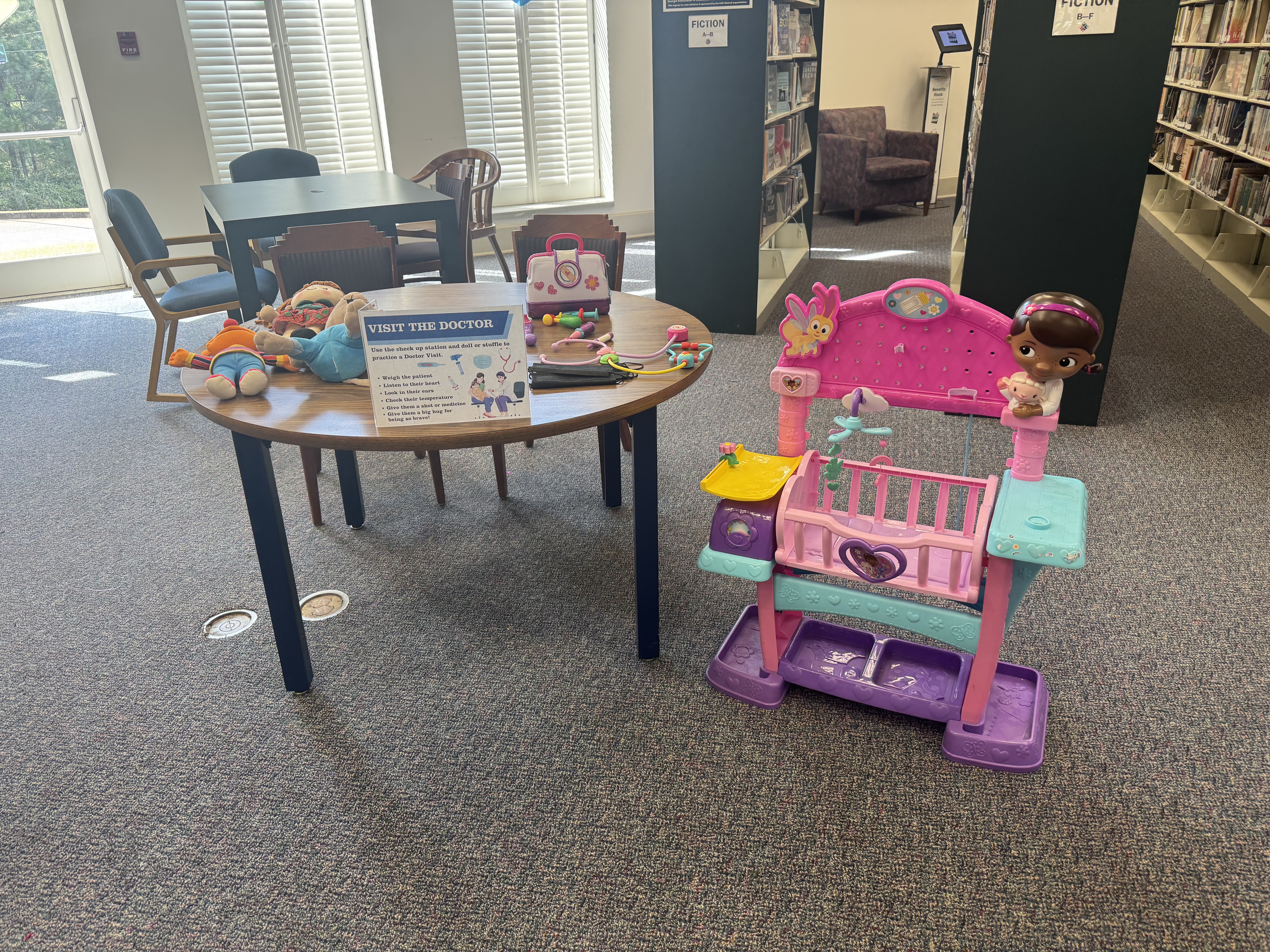 The Oglethorpe County Library used toys to help parents and children talk through what to expect at a doctor’s visit during the Family Health Resource Fair on Saturday, Aug. 30, 2025. From checkups to shots, the activity aimed to ease anxieties about health care. (Photo/Maura Rutledge)