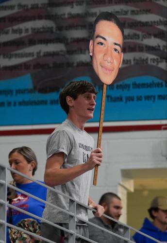 A student holds a cut out of wrestler Brian Valladares’ head during Saturday’s matches against Coosa and Putnam. (Sarah White/The Oglethorpe Echo)