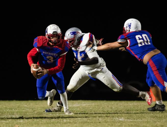 Seniors Jonathon Cronic (30) and Skylor Prince (40) combine to tackle a Westside-Augusta player. (Photo/Sarah White)