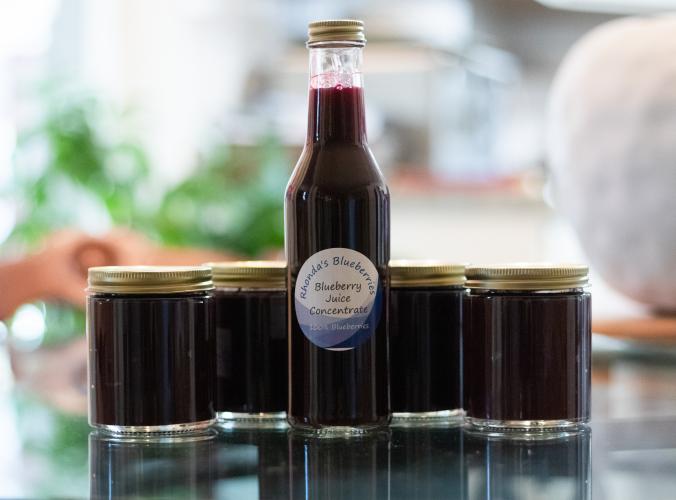 Rhonda's blueberries are sold in bottled and jarred blueberry products. Outside of blueberry season, the couple sells plants and blueberry products such as these concentrates and jams. (Photo/Sarah White)