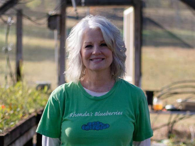 Rhonda Luther poses for a portrait in the propagation area on Rhonda and Chris Luther's blueberry farm. The Luthers started blueberry farming in 2007 after moving to Oglethorpe County years prior. (Photo/Sarah White)