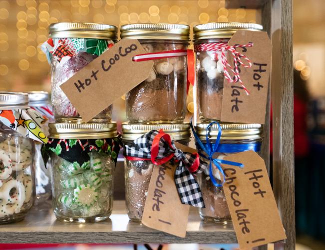 Handmade jars of hot chocolate mix and other sweets sit on a shelf at a vendor booth. Vendors sold a wide variety of goods ranging from jewelry to home decorations to homemade fudge. (Photo/Sarah White)