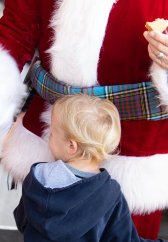 A child hugs Santa Clause (aka Anderson) who lives in Lilburn, but travels to Oglethorpe County and other areas to appear as Santa during the holiday season. (Photo/Sarah White)
