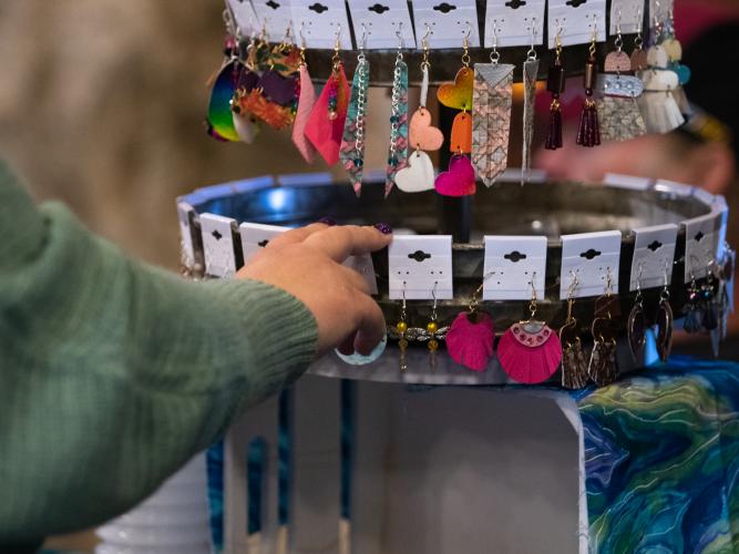 A visitor spins a rack of earrings. According to Linda Parish at the Chamber of Commerce, almost all of the vendors at the market are from Oglethorpe County. (Photo/Sarah White)