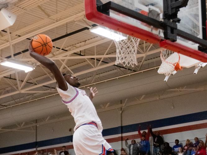 Nick Hugg soars for a dunk in for Oglethorpe County's 58-54 overtime win over Monticello on Friday night. He finished with 16 points in that victory. (Photo/Sarah White)