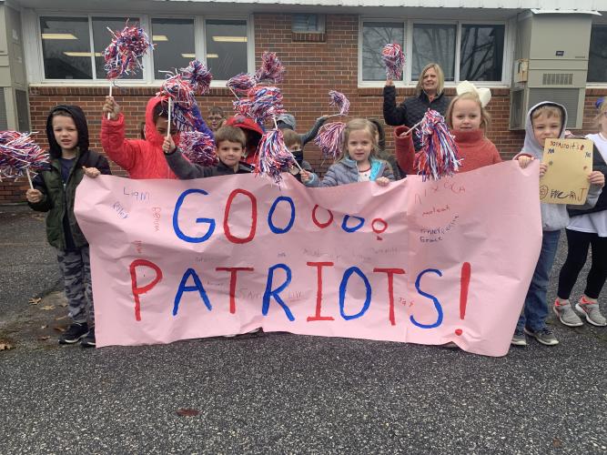 Oglethorpe County Primary School students show off their poster during a sendoff for the OCHS wrestling team. (Meredith Boyd/The Oglethorpe Echo)