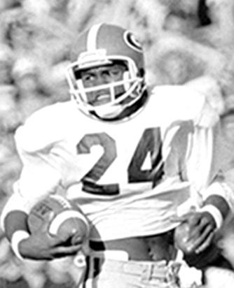 Two Bulldogs who helped Georgia win national championships in 1980 and 2021 have Jesup connections. Fred Bennett’s 1980 photo of Jesup’s Lindsay Scott, center, shows No. 24 racing to the Florida Gators’ end zone in Jacksonville. That play propelled the Dawgs into the national championship game against Notre Dame. Stetson Bennett IV, right, is the grandson of the late Buddy Bennett, left, who quarterbacked Jesup High School to a state championship in 1954. (Submitted Photos)