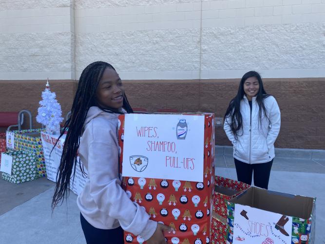 Breanna Crowder (left) and Amy Sagastume help with boxes of donations at the Oglethorpe County Emergency Medical Services Fill the Ambulance drive last Saturday at the Target in Athens. (Photo/Julianna Russ)