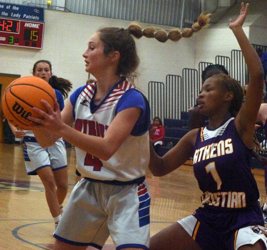 Elin Turner, who is in the eighth grade, keeps the ball away from an Athens Christian School defender in a game on Dec. 2. (Photo/Ralph Maxwell)