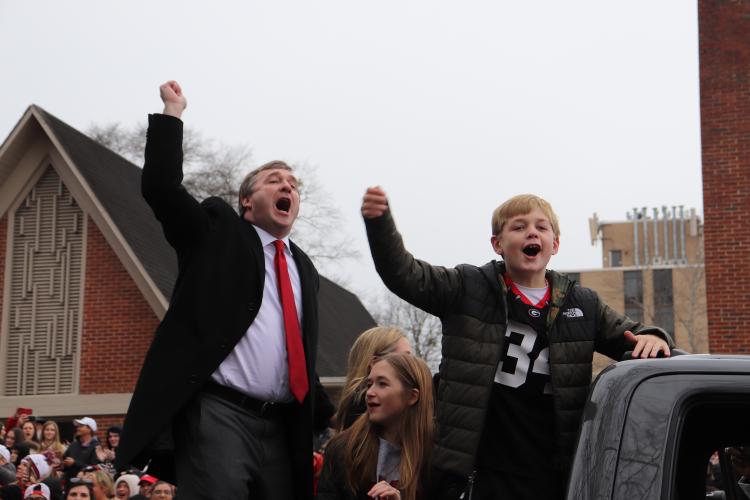Georgia coach Kirby Smart, son, Andrew, and the Smart family, help fire up the thousands of UGA fans who packed the parade route on Saturday. (Photo/Julianna Russ)