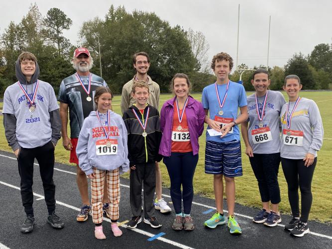 Tanner Mask (back row, from left), Randy Booth, Noah Huff-Merck, (front row, from left) Lannah Scarborough, Micah Dixon, Jennifer Dixon, Noah Dixon, Caroline Paradise Jenny Wisham, were the winners of the Patriot 5k. (Submitted Photo)