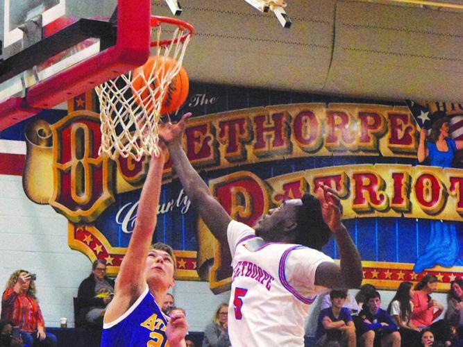 Oglethorpe County's Nick Huff soars for a ball in the Patriots' 57-47 victory over Athens Christian on Tuesday night. Huff scored 15 points in the home victory. (Photo/Ralph Maxwell)