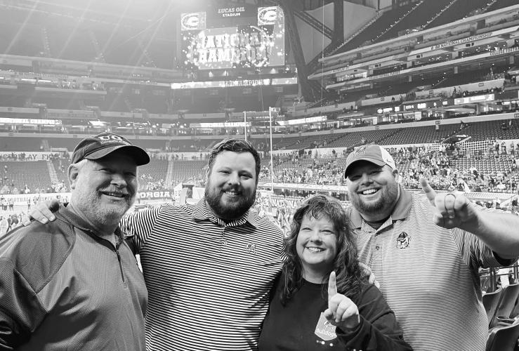 Like many UGA fans at the national championship game, the Taylor family (from left): Gerald (dad), Ethan (son), Lane (mom) and Levi (son) hung around Lucas Oil Stadium to watch the celebration and trophy presentation. Levi, who is the voice of the Oglethorpe County football team, said: “​​We are so proud for all of Dawg Nation and I can’t think of anyone else I would have rather beat than Nick Saban and Bama!” (Submitted Photo)