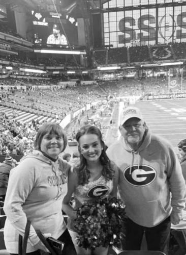 Iris Walker (left) and Barry Walker took a photo with OCHS grad Addie Dellinger, a majorette with UGA’s Redcoat Marching Band, before the start of the game at Lucas Oil Stadium. (Submitted Photo)