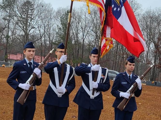 The Civil Air Patrol's Clarke County Composite Squadron presents the American flag during the National Wreaths Across America Day at Winterville Cemetery on Dec. 18.