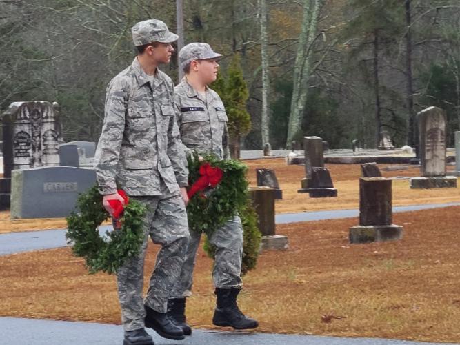 Members of the Civil Air Patrol's Clarke County Composite Squadron (bottom) carry wreaths to place on the graves of veterans at Winterville Cemetery. (Submitted Photo/Sharon Doherty)