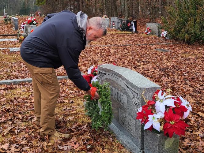 Kevin "Chappy" Hynes places a wreath on the grave of a veteran during the National Wreaths Across America Day at Winterville Cemetery. (Submitted Photo/Sharon Doherty)