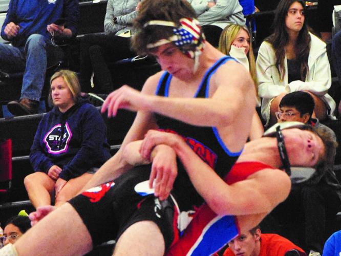 Oglethorpe County's Tanner Mask picks up and slams a Jefferson wrestler in the Panther Invitational at Jackson County last weekend. The Patriots finished second in the match. (Photo/Ralph Maxwell)