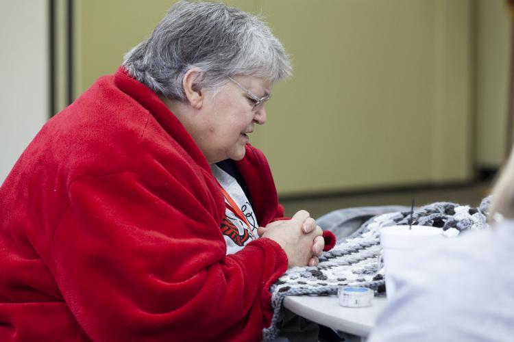 (Sydney Fordice/Oglethorpe Echo) Rebecca Smith prays for members of the crocheting group Covered With Love during a bimonthly meeting at Lexington Baptist Church.