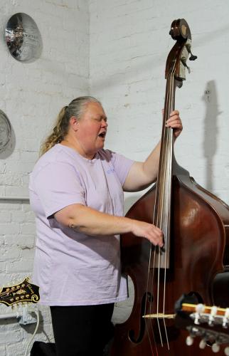Deirdre Smith plays the bass and sings a bluegrass tune with her band. The group performs at G Brand BBQ in Crawford every Thursday night.  (Shannon Moran/The Oglethorpe Echo)