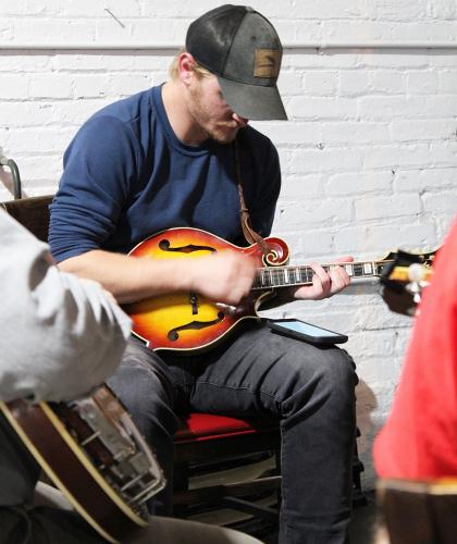 Robert Smith strums his mandolin at G Brand BBQ. Smith and his bluegrass band improvise and take turns playing the lead. (Shannon Moran/The Oglethorpe Echo)