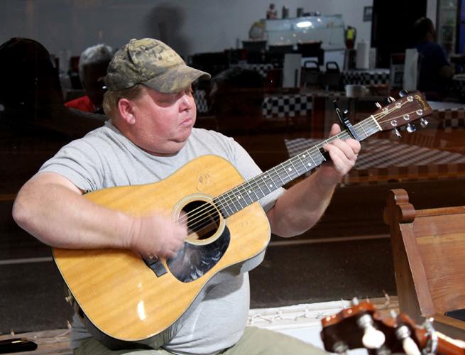 John Smith plays the guitar with his band at G Brand BBQ in Crawford. Their performance was met with applause.  (Shannon Moran/The Oglethorpe Echo)