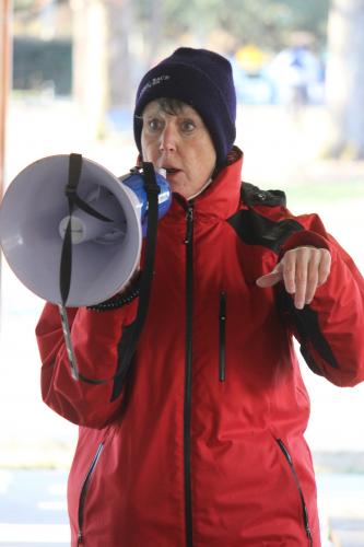 Carole Black gives instructions to runners at the Winterville Civitan Snowflake 10k on Saturday. (Mackenzie Tanner/The Oglethorpe Echo)