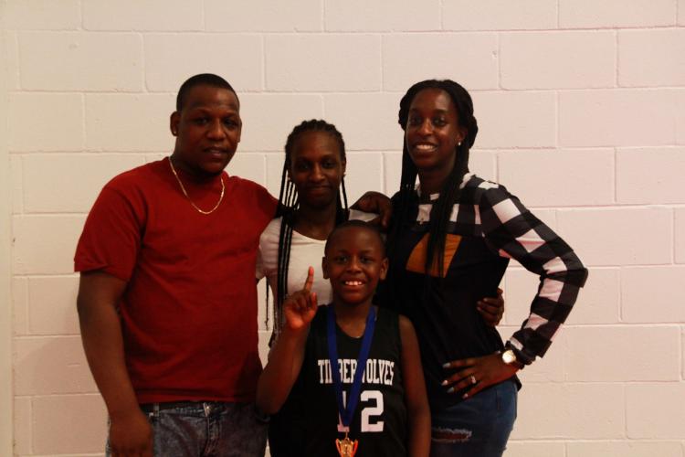The Mattox family celebrates after the 8U Championship win. (Armani Kardar/The Oglethorpe Echo)