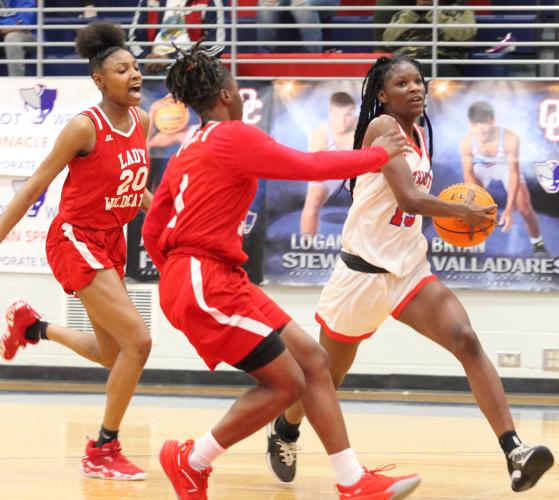 Oglethorpe County’s Kenzie Henderson races past two Laney defenders on her way to the basket on Tuesday night. Henderson scored 21 points in the loss. (Ralph Maxwell/Submitted Photo)