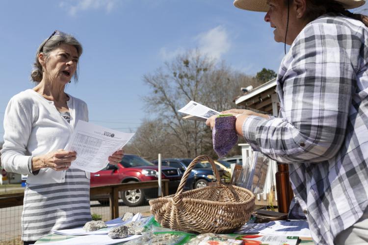 Dee Dee Hice (left), asks questions of UGA Extension master gardener Lamara Martin (right), who volunteered at the Seed Swap and One-Day Book Sale at No. 3 Railroad Street on Saturday. (Sydney Fordice/The Oglethorpe Echo)