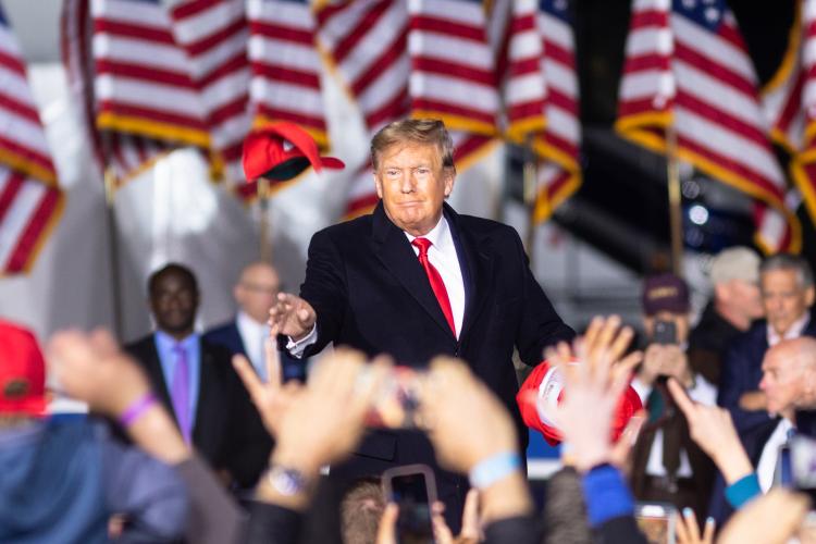 Former President Donald Trump throws hats into the crowd at a Save America rally held at the Banks County Dragway in Commerce on Saturday. (Julian Alexander/For The Oglethorpe Echo)