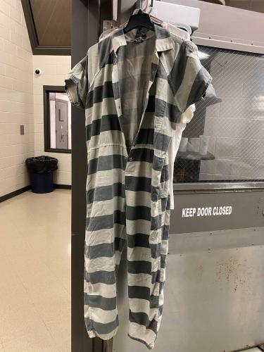 An unused jail uniform hangs from the laundry room door at the Oglethorpe County Jail. (Jamie Miller/ The Oglethorpe Echo)