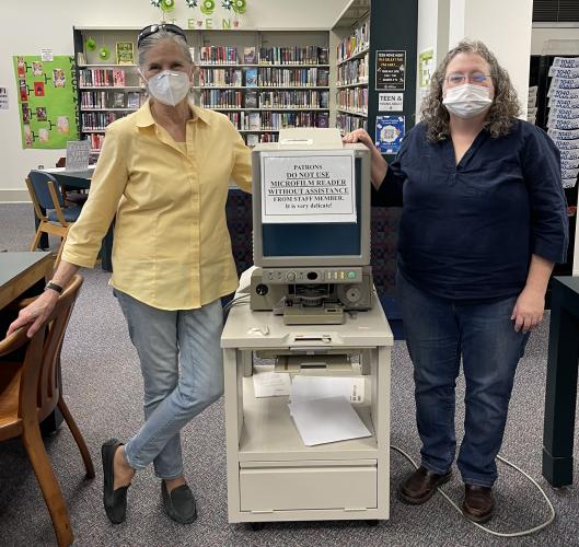 Jean Westmacott and Amanda Chapman stand next to the old microfilm reader in the  Oglethorpe County Library that needs to be replaced because it no longer works. (Submitted Photo)