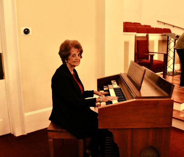 Nina Hayes poses with the organ that she played every Sunday for 59 years at the Salem Baptist Church. Eloise McNair/The Oglethorpe Echo