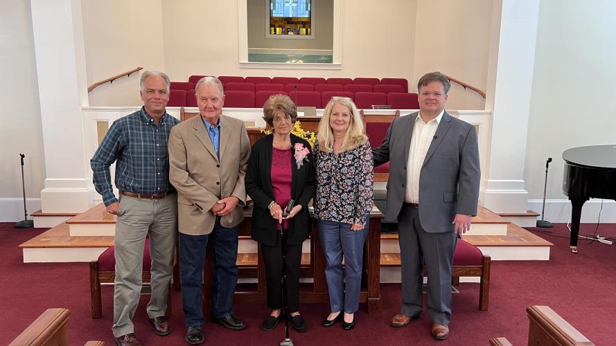 Nina Hayes poses with her family and Pastor Brett Mask at her retirement celebration at Salem Baptist Church on Sunday. Standing in front of the altar (left to right) is Steve Hayes, Joe Gene Hayes, Nina Hayes, Donna Floyd, and Brett Mask. Brett Mask/Submitted photo