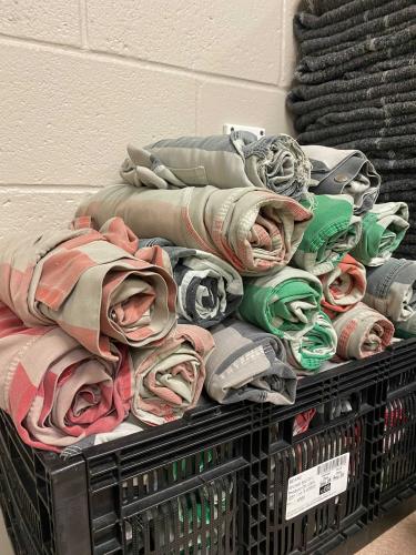 A crate of unused jail uniforms are stacked against a wall at the Oglethorpe County Jail.  (Jamie Miller/ The Oglethorpe Echo)