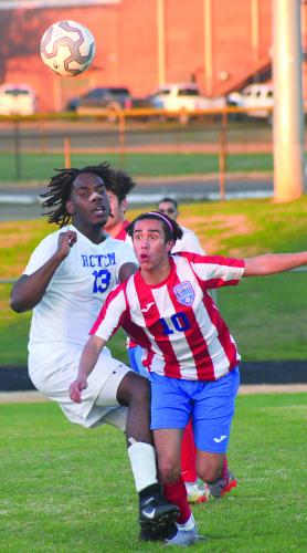 Oglethorpe County's Demetrio Rios (No. 10) hustles for a loose ball despite the efforts of a Richmond County Technical Career Magnet School player. (Ralph Maxwell/ Submitted Photo)