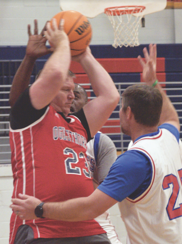 Philip Nelson, a ranger with the Department of Natural Resources, grabs a rebound during the community basketball fundraiser games at OCHS on March 24. The coaches played the community in one game and the faculty played the students in the other game. (Ralph Maxwell/Submitted Photo)